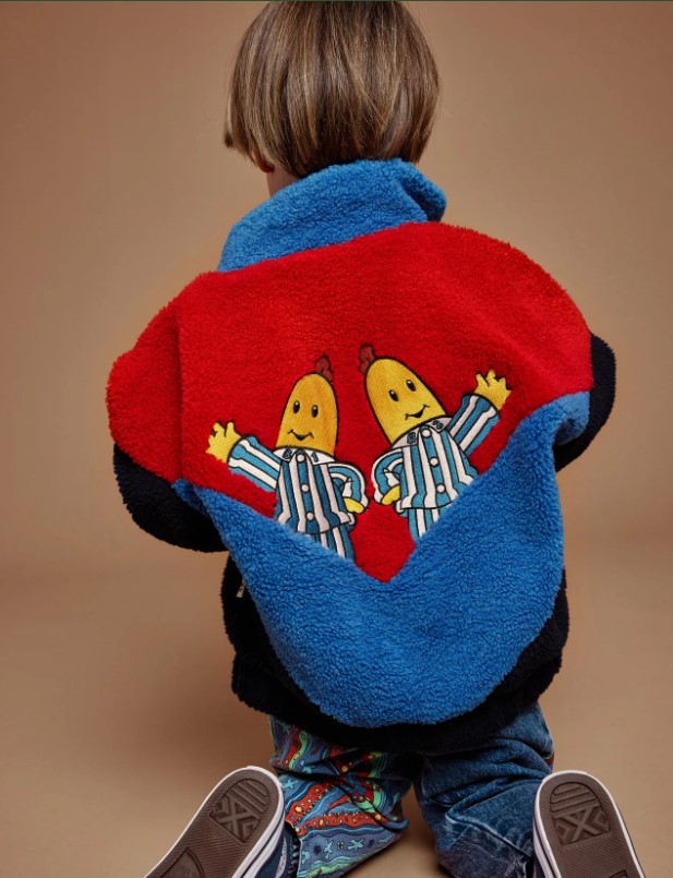 Boy faces back to camera, wearing a Bananas in Pyjamas.