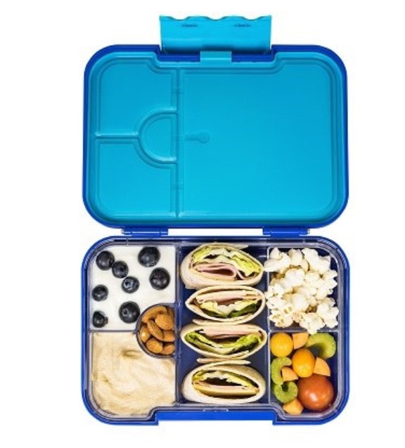 Blue lunchbox with popcorn, blueberries, wraps and other snacks.