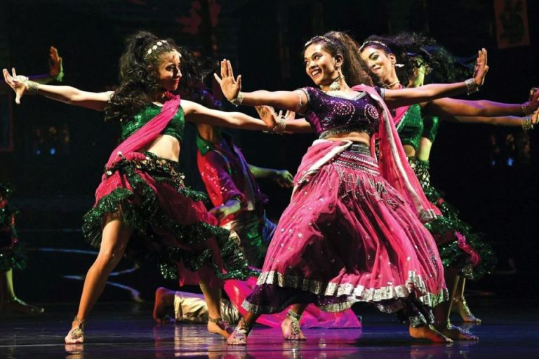 Bollywood dancers performing in colourful traditional attire.