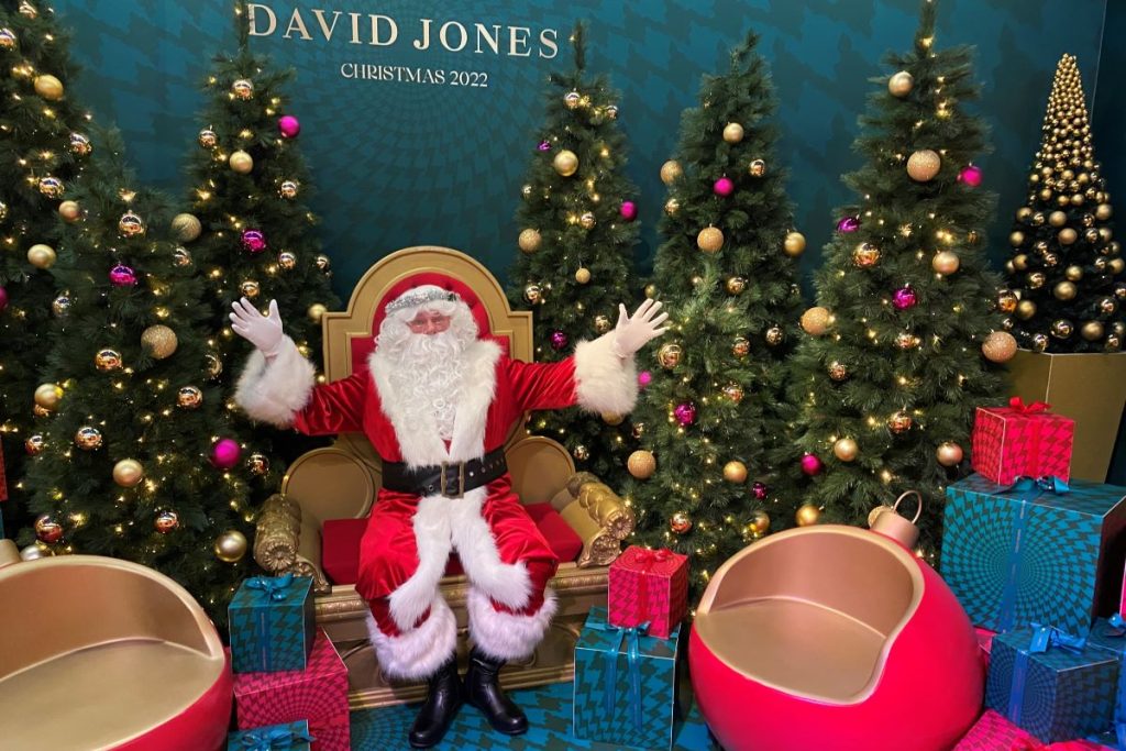 Santa waves to the camera at David Jones.