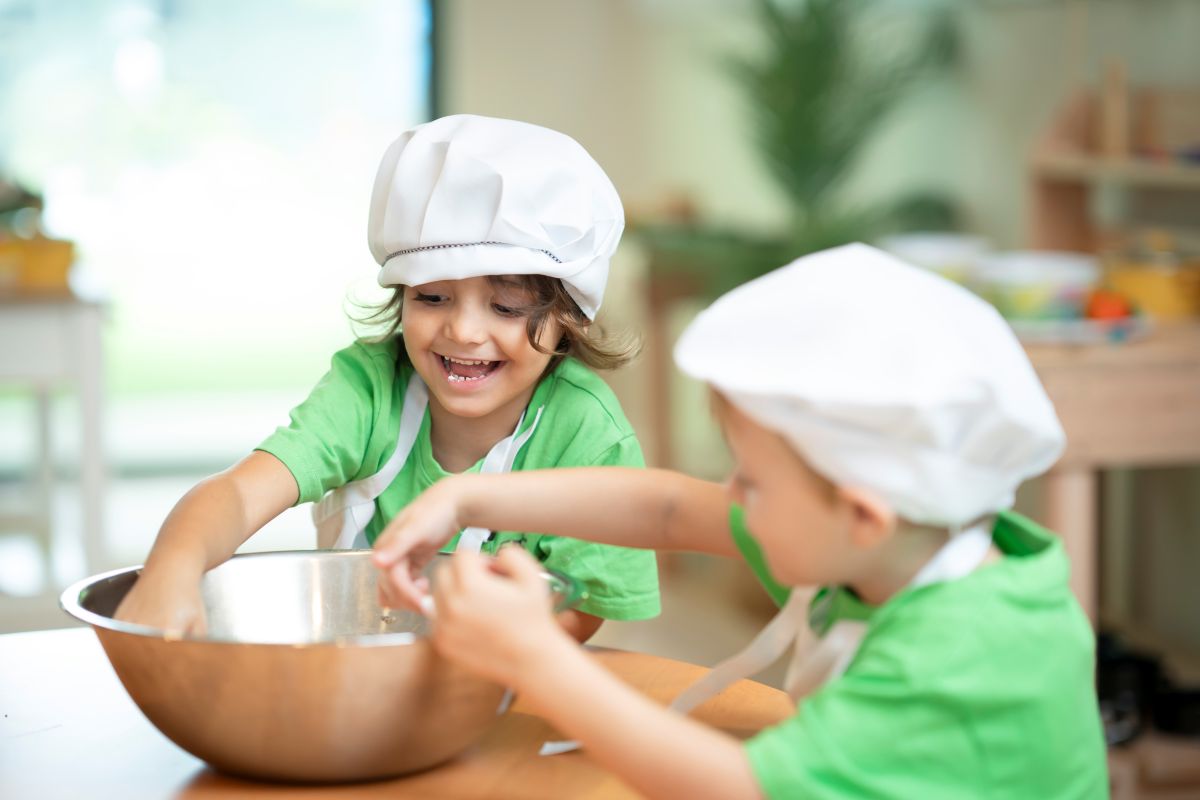 Two children cooking in kitchen.