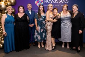 Group of people at a formal awards ceremony.