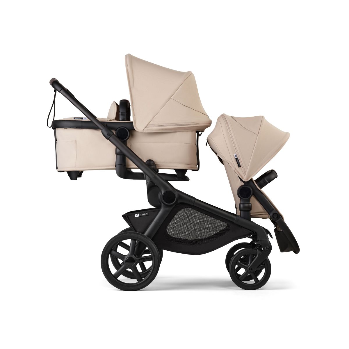  A beige and black stroller is parked on a sidewalk, showcasing its stylish and modern design.