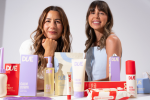 Two women seated at a table, surrounded by a diverse array of products, engaged in conversation and exploration.