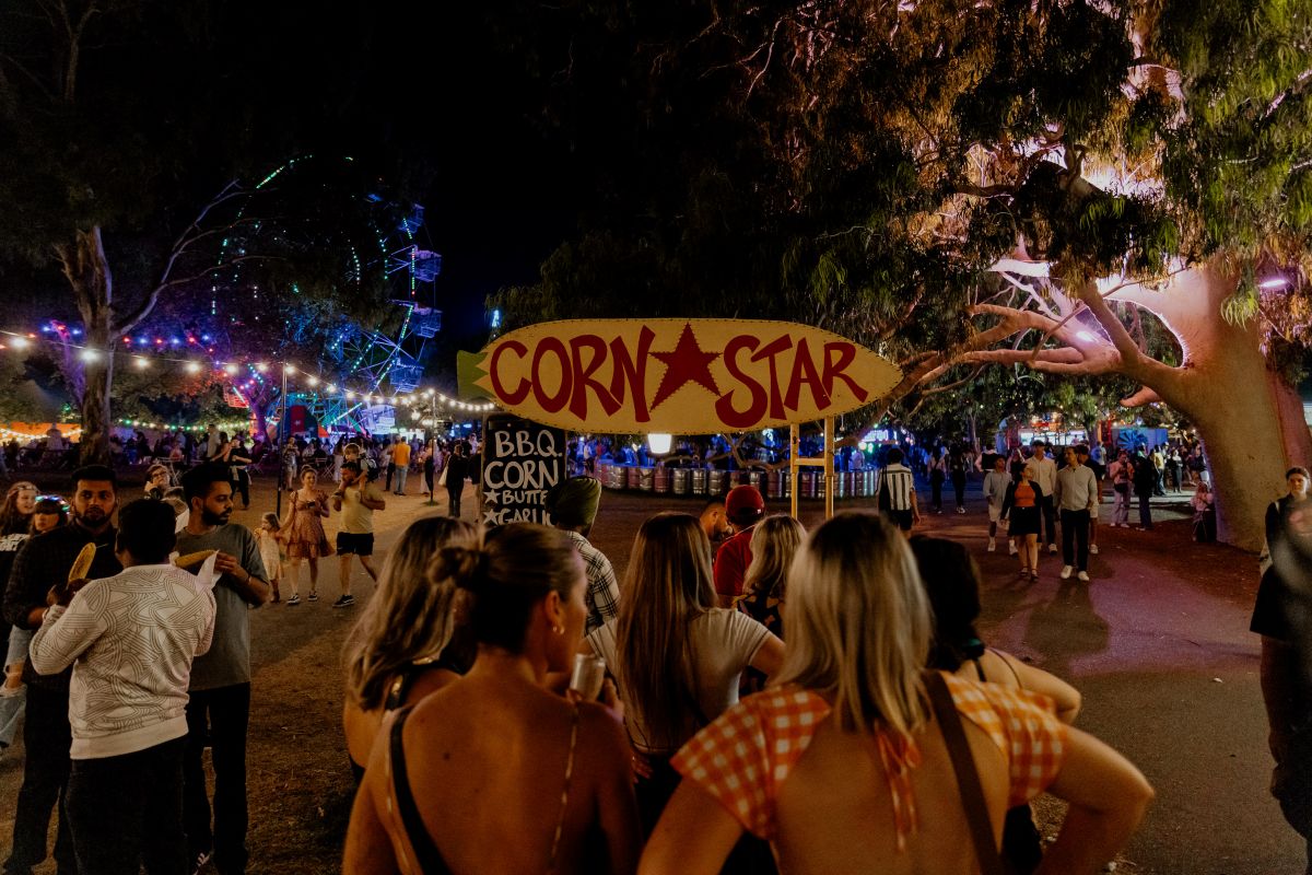 A vibrant scene from the 2019 Corn Star Festival, showcasing colorful decorations and lively crowds enjoying the festivities.