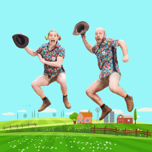 Two people joyfully jumping in the air above a vibrant green field under a clear blue sky.