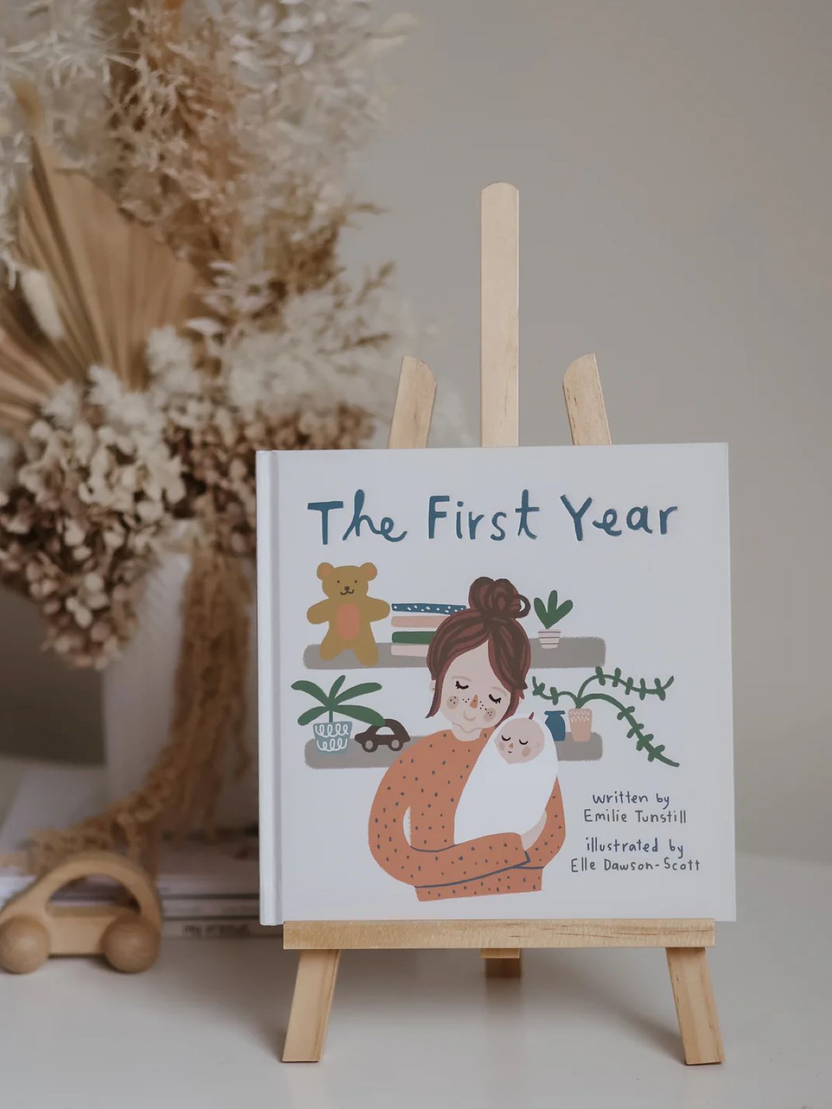 A first-year book sits on a book holder on a table.