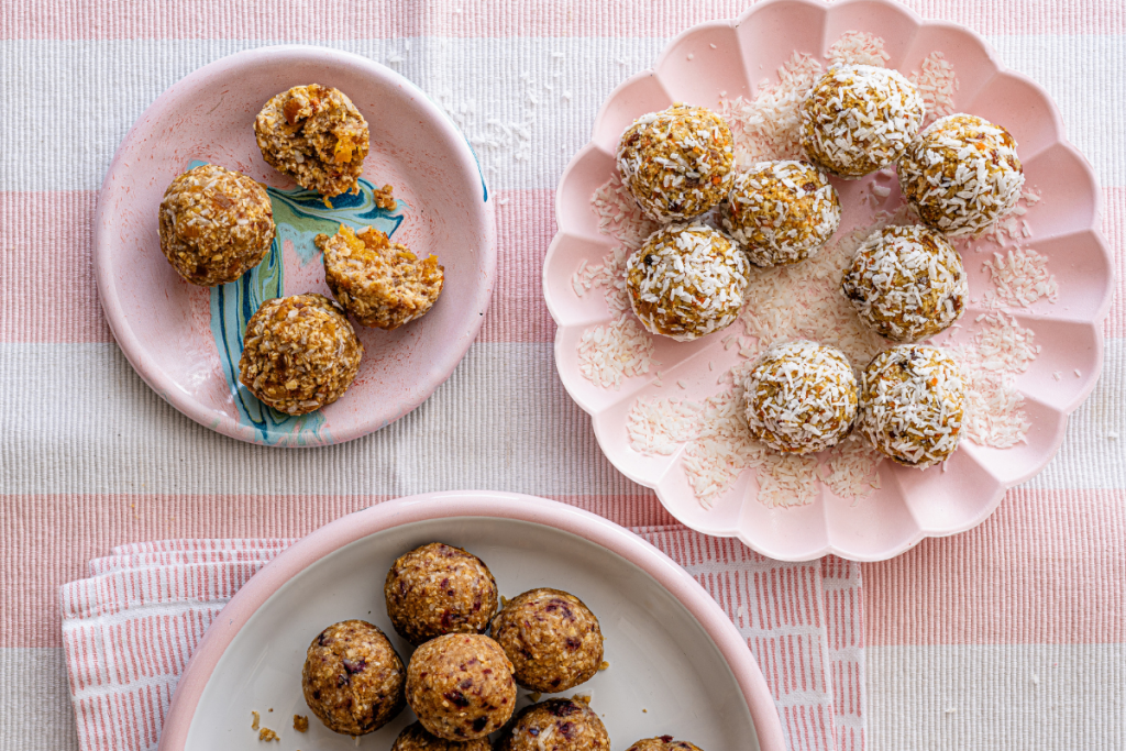 A pink and white striped tablecloth drapes elegantly over a table with energy balls.