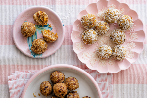 A pink and white striped tablecloth drapes elegantly over a table with energy balls.