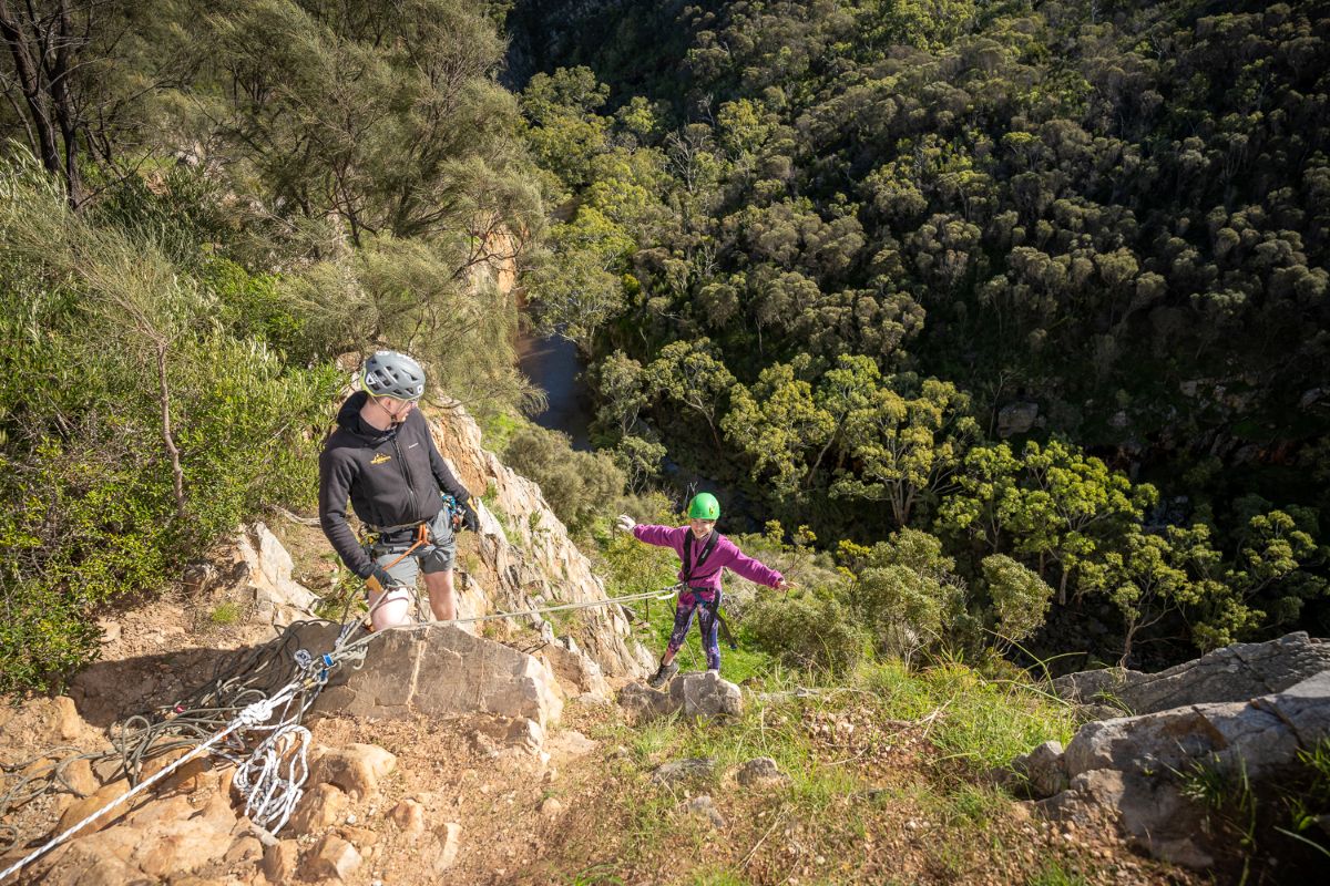 Two people rockclimbing.