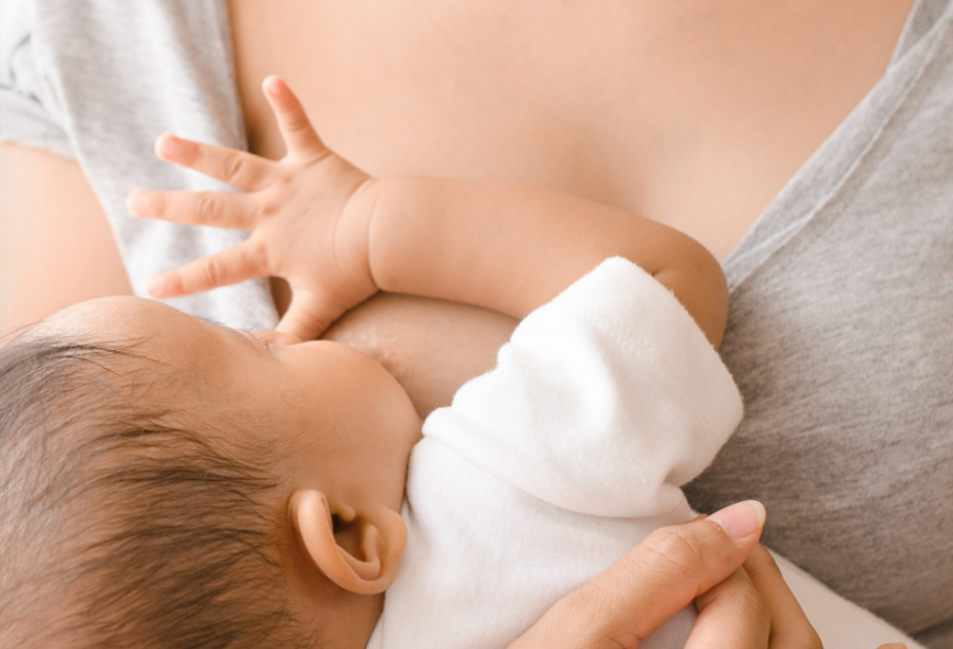 A mother breastfeeding her baby, highlighting the importance of breastfeeding for the baby's health and development.