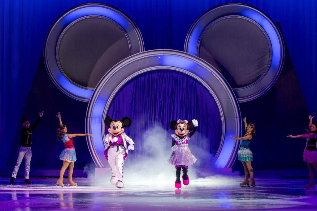 Disney on Ice performance featuring colorful characters and ice skating in a festive atmosphere.