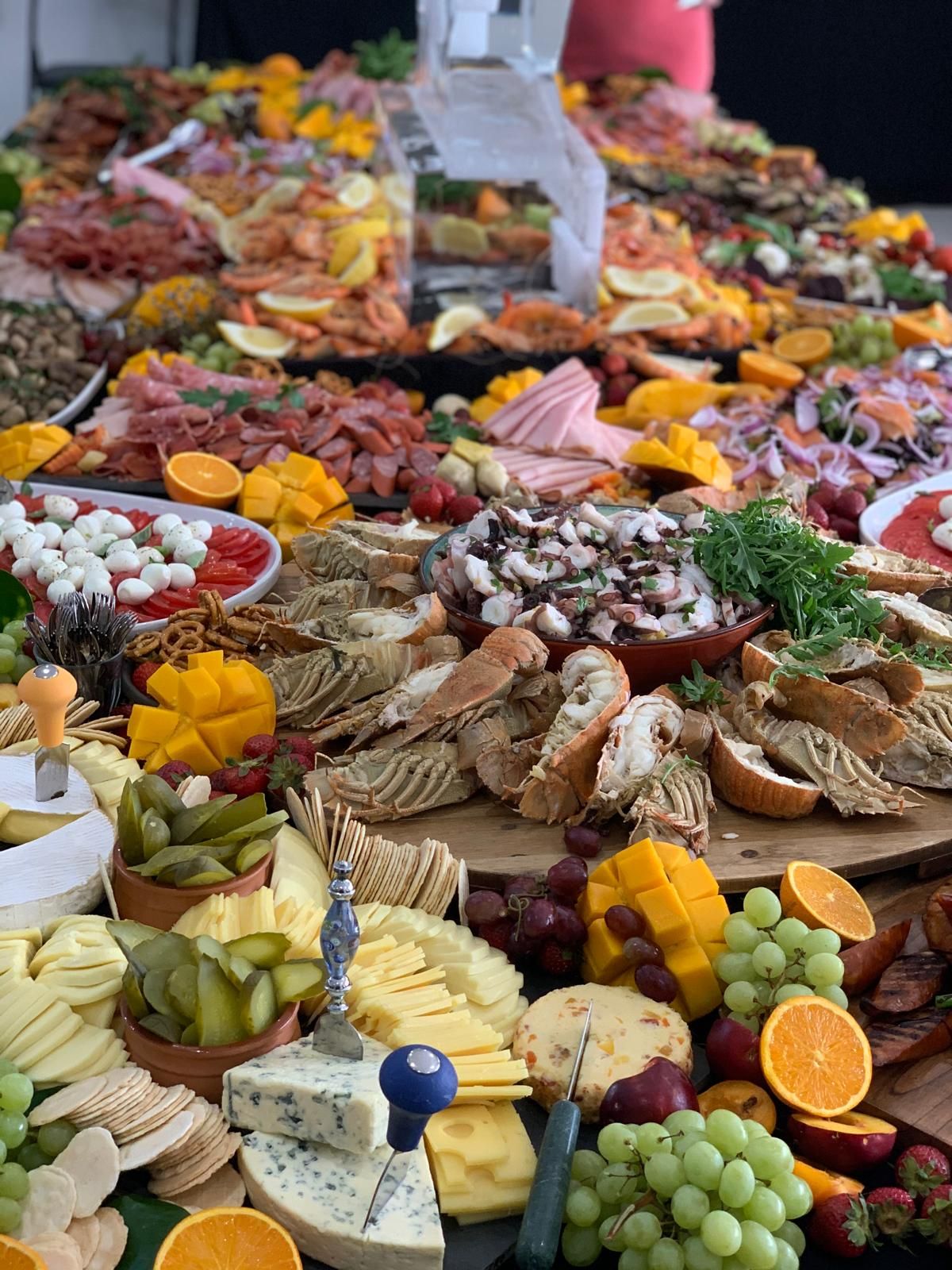 A large buffet table filled with a variety of dishes, including salads, meats, and desserts.
