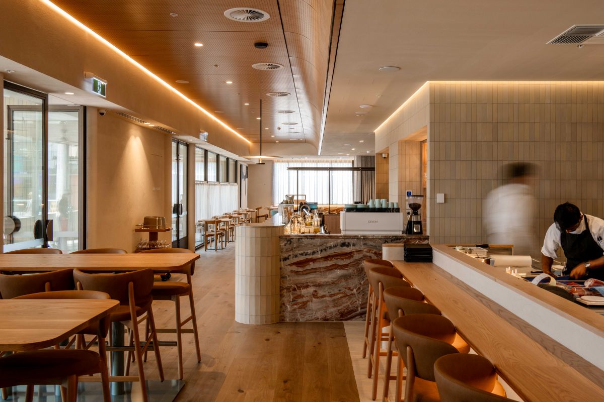 A cozy restaurant featuring wooden tables and chairs arranged for dining.