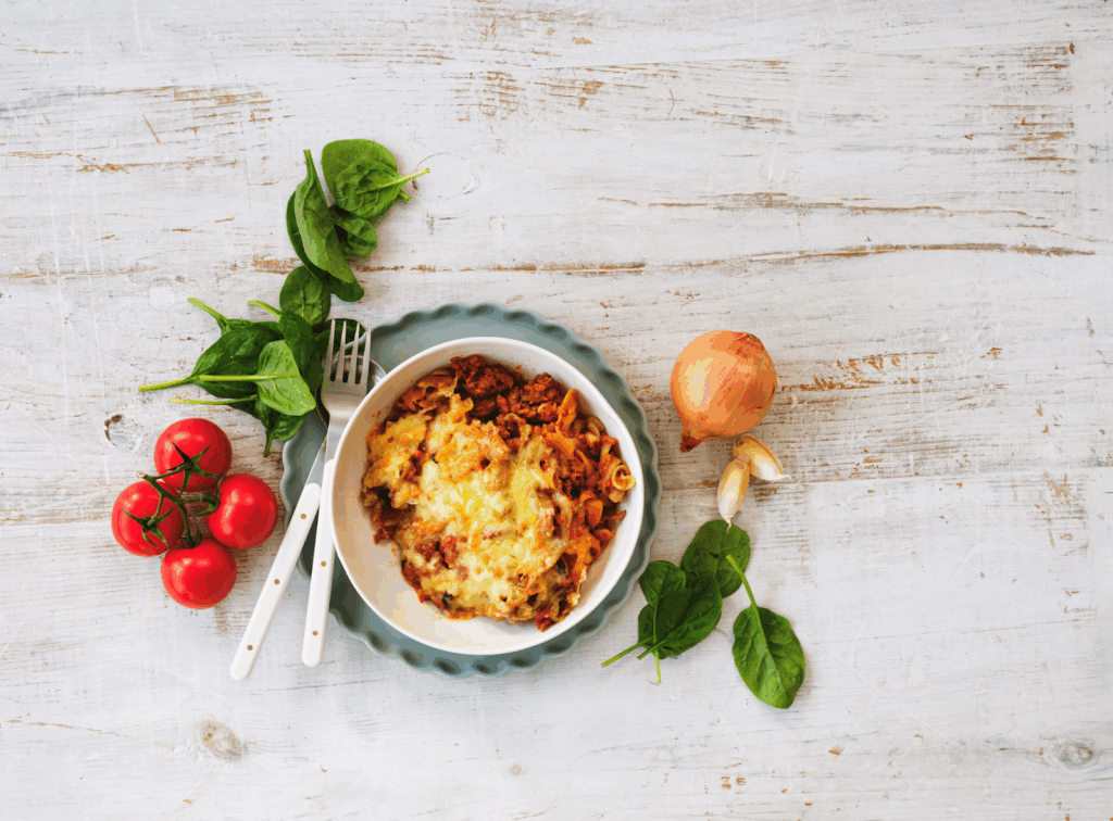 A bowl filled with colorful vegetables and ripe tomatoes, showcasing a healthy and vibrant meal.
