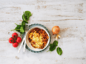 A bowl filled with colorful vegetables and ripe tomatoes, showcasing a healthy and vibrant meal.