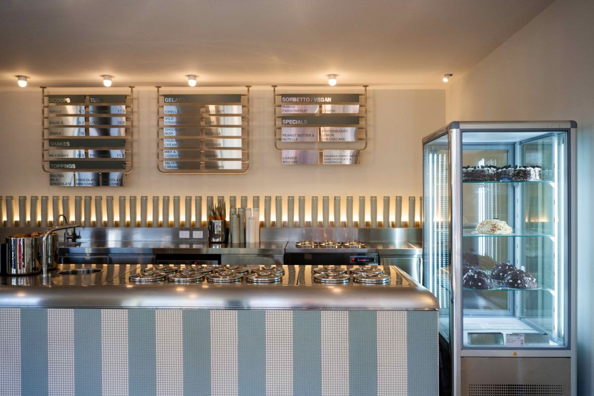 A kitchen featuring a counter and a shelf, showcasing a clean and organised cooking space.