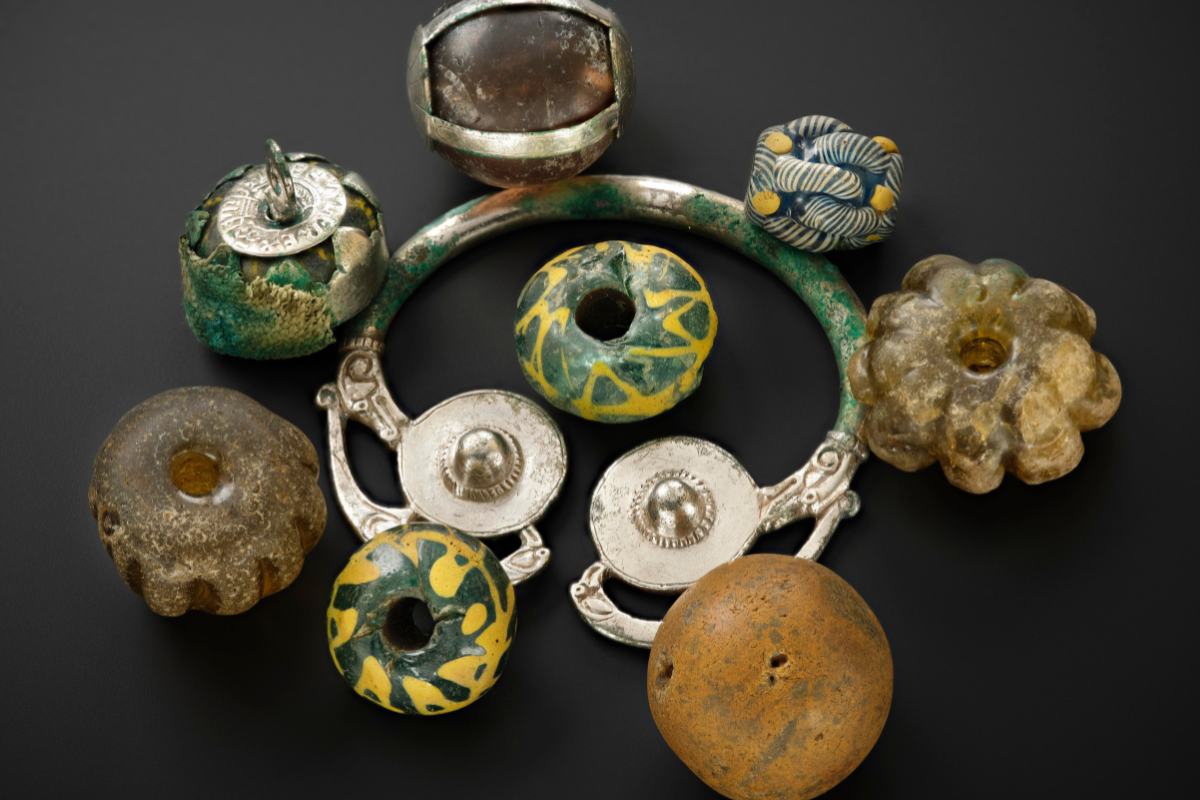 A colorful bracelet featuring a variety of beads and decorative items.