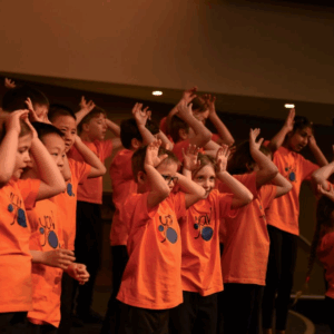 Child choir in orange.