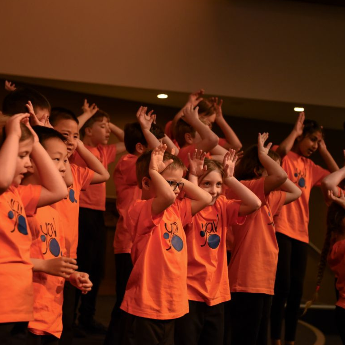 Child choir in orange.