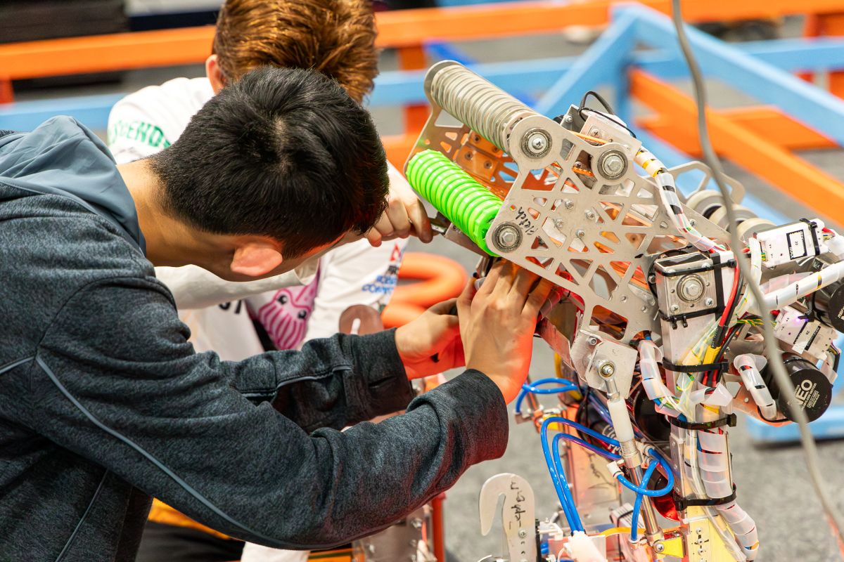A boy assembling a robot.