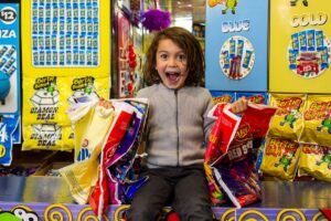 Child holding showbags.
