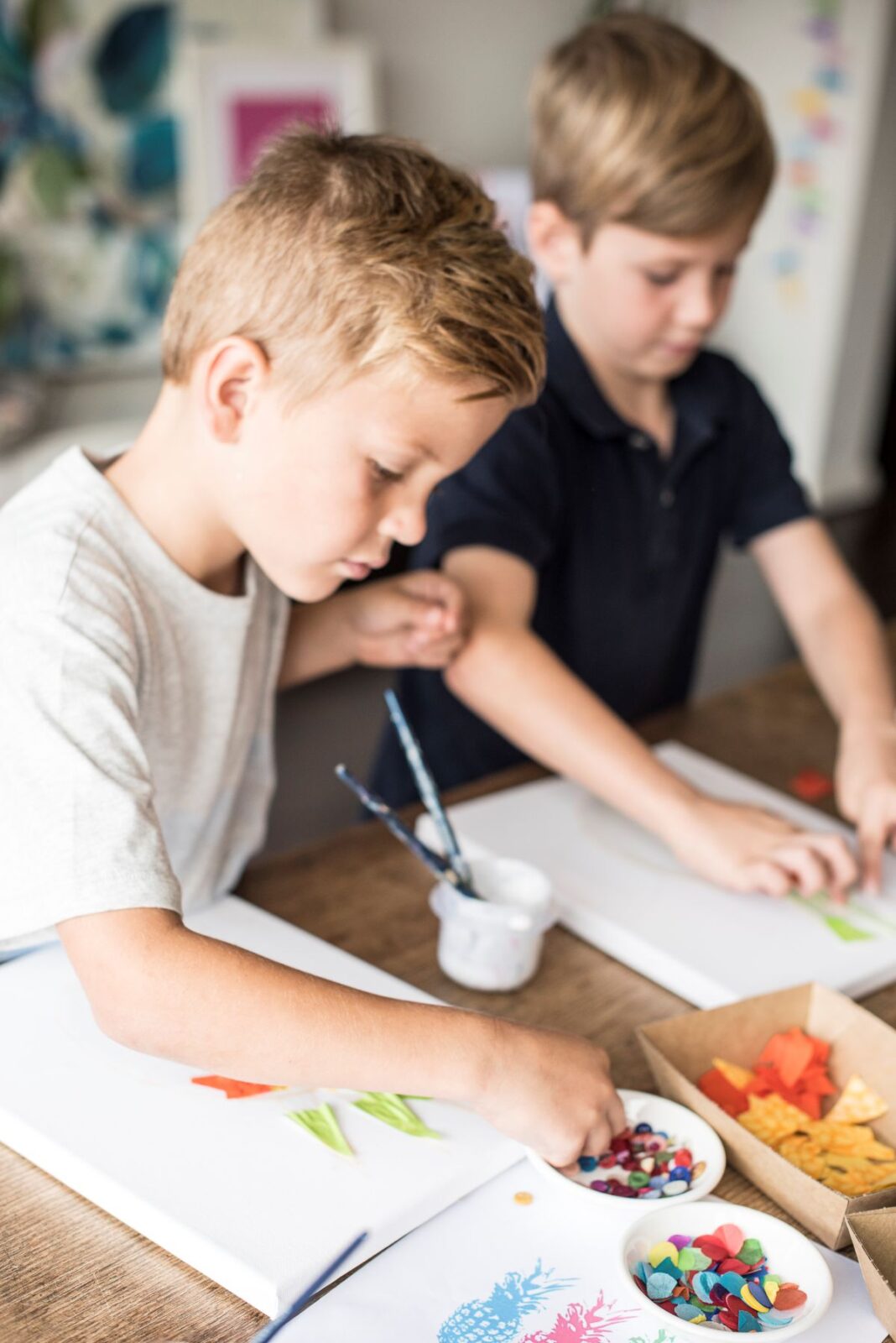 Two boys are happily creating art.