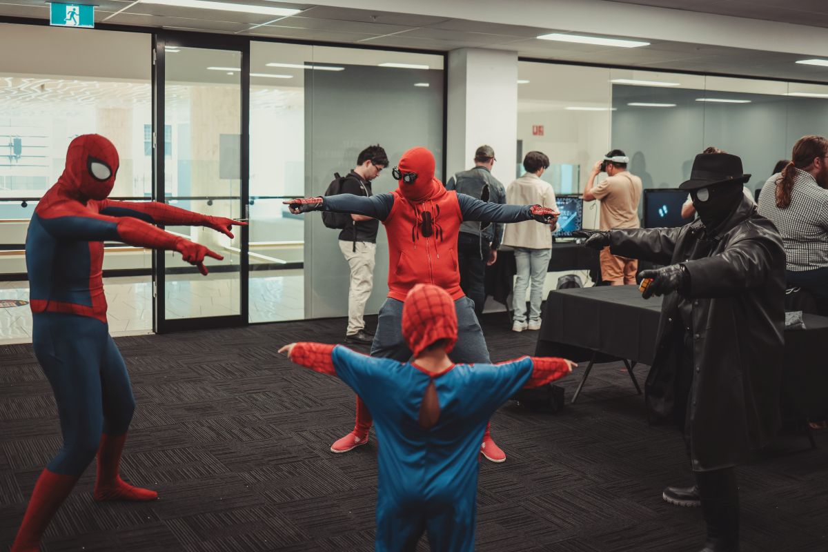 Spider-Man and various superheroes networking at a business event, showcasing a blend of heroism and professionalism.