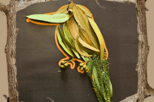 A bird sculpture crafted from leaves and branches, showcasing intricate natural textures and forms.