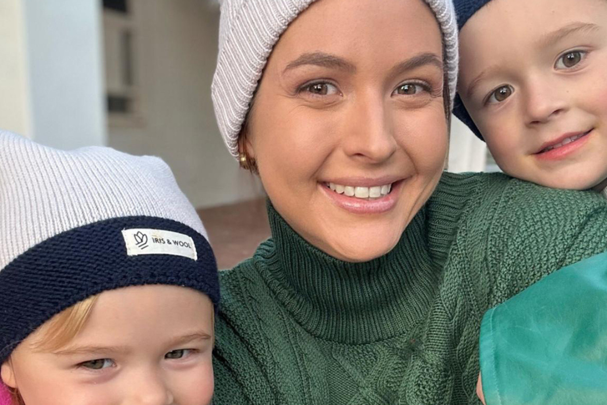 A woman and two children wearing colorful beanies
