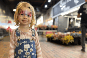 Child with face painted.