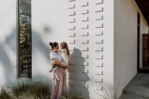 A mum embraces her child.