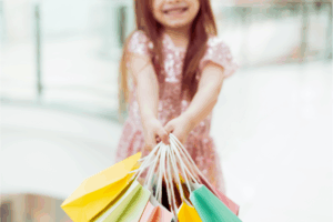 Girl holds shopping bags.