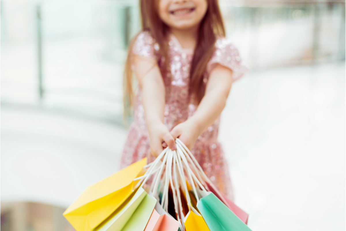 Girl holds shopping bags.