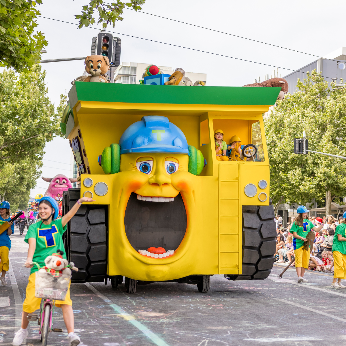 A yellow and green truck parked on a street, showcasing its vibrant colors and sturdy design.
