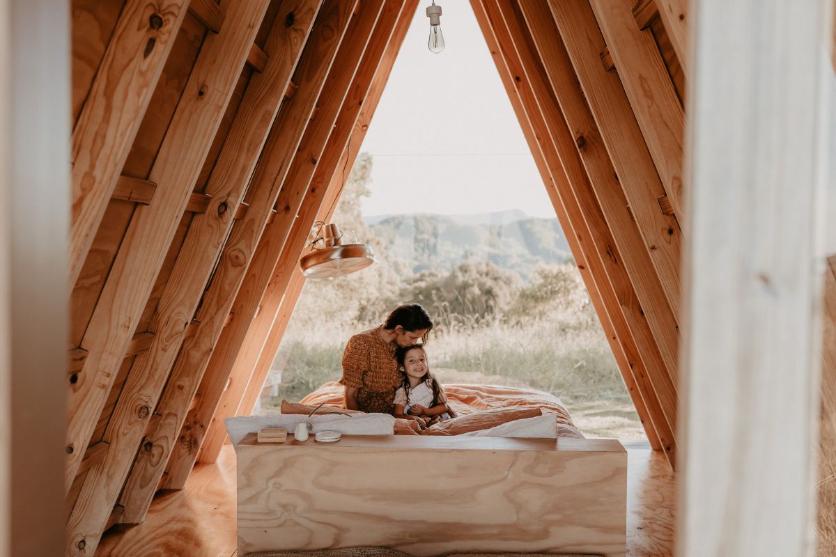 A mum hugs her child on the bed.