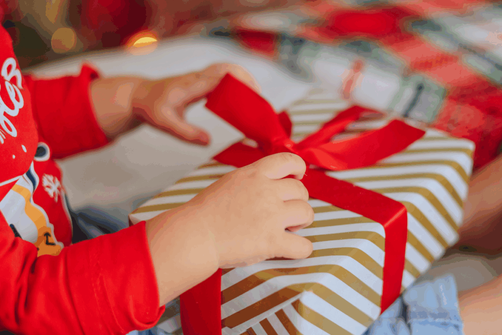 Child unwraps gift.