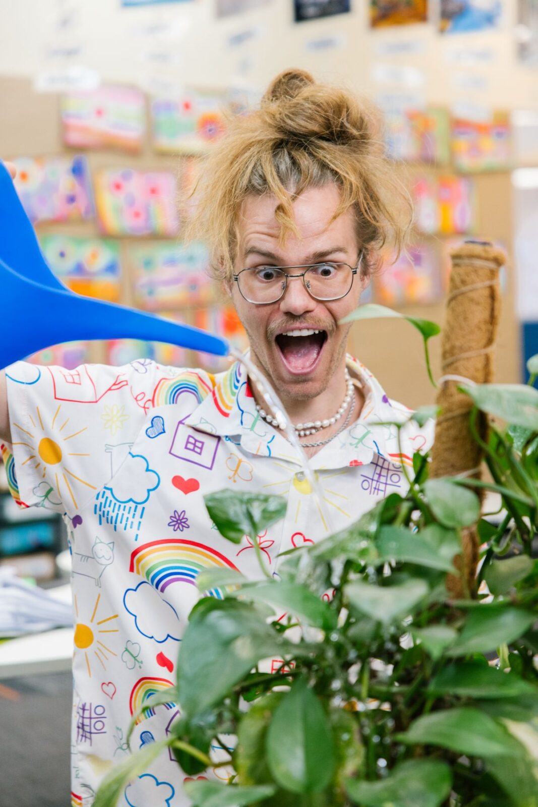 Mr Luke watering a plant.