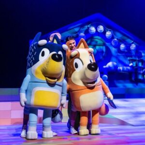 Two cartoon characters perform on a stage in an entertaining scene