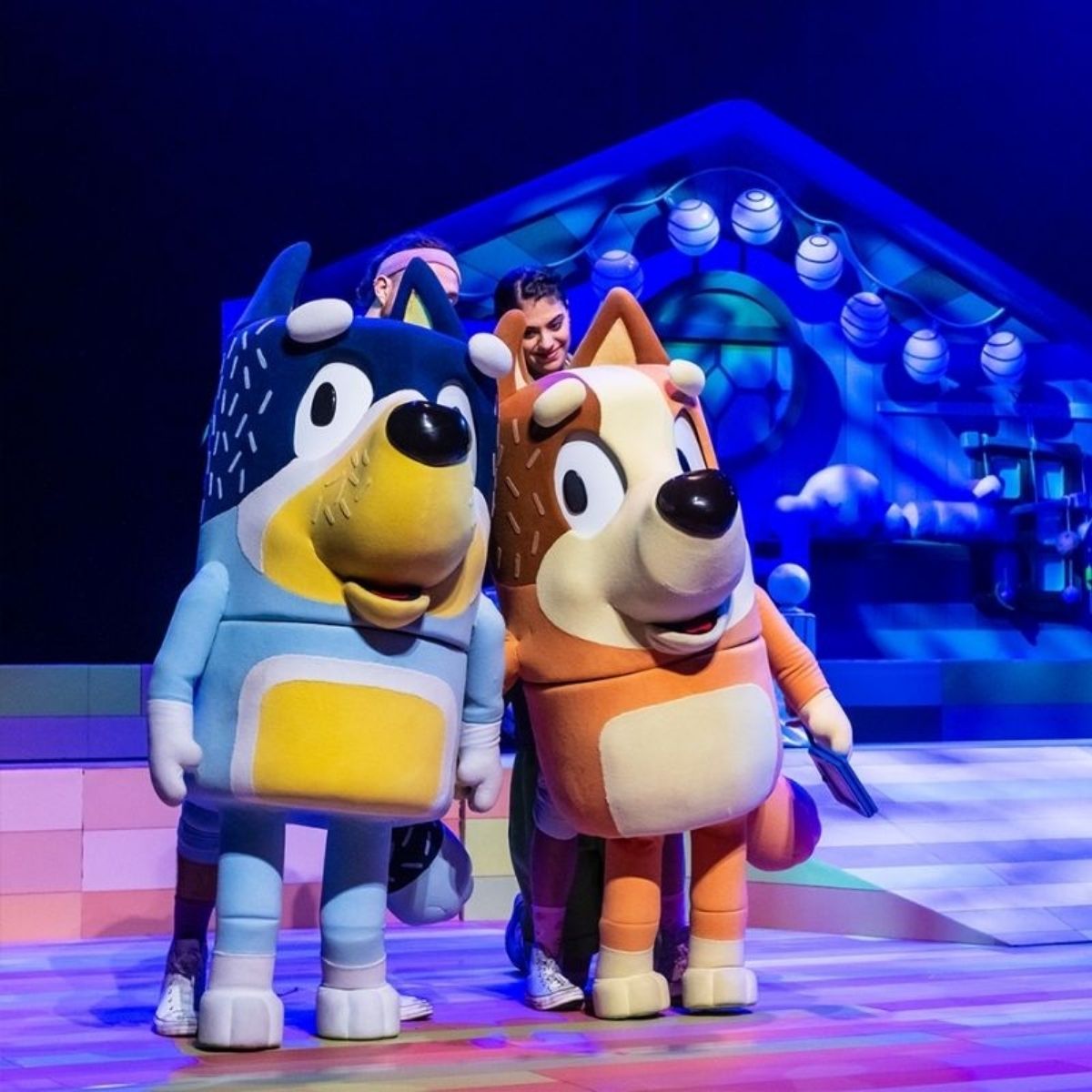 Two cartoon characters perform on a stage in an entertaining scene