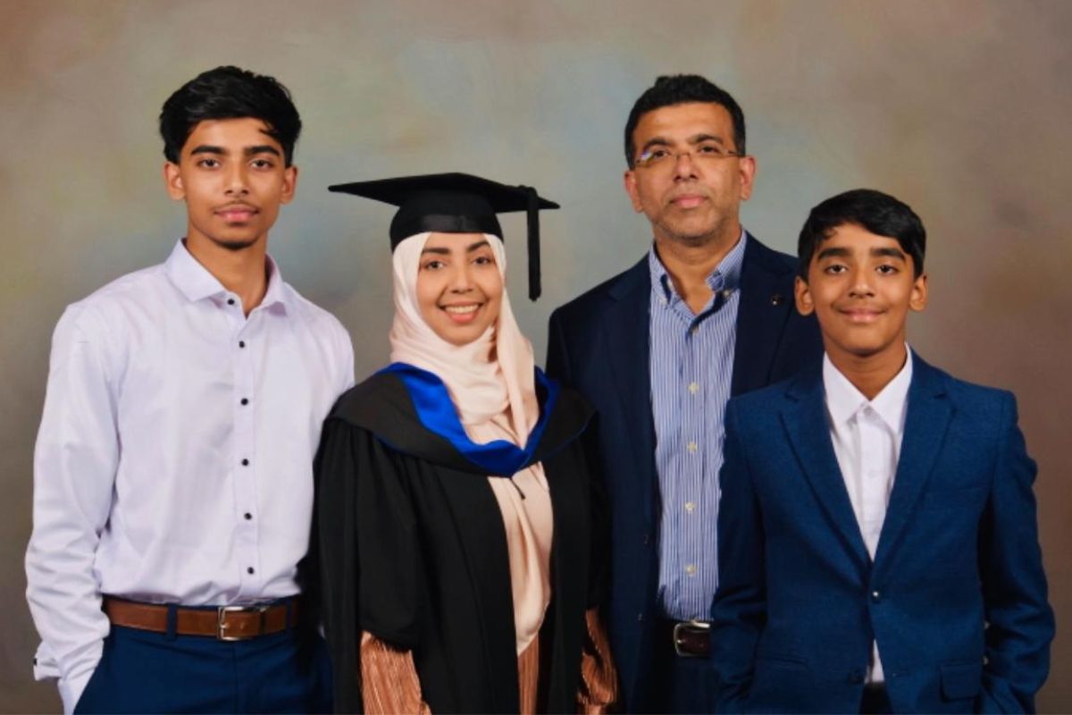a family pose for a portrait photo dressed in graduation attire