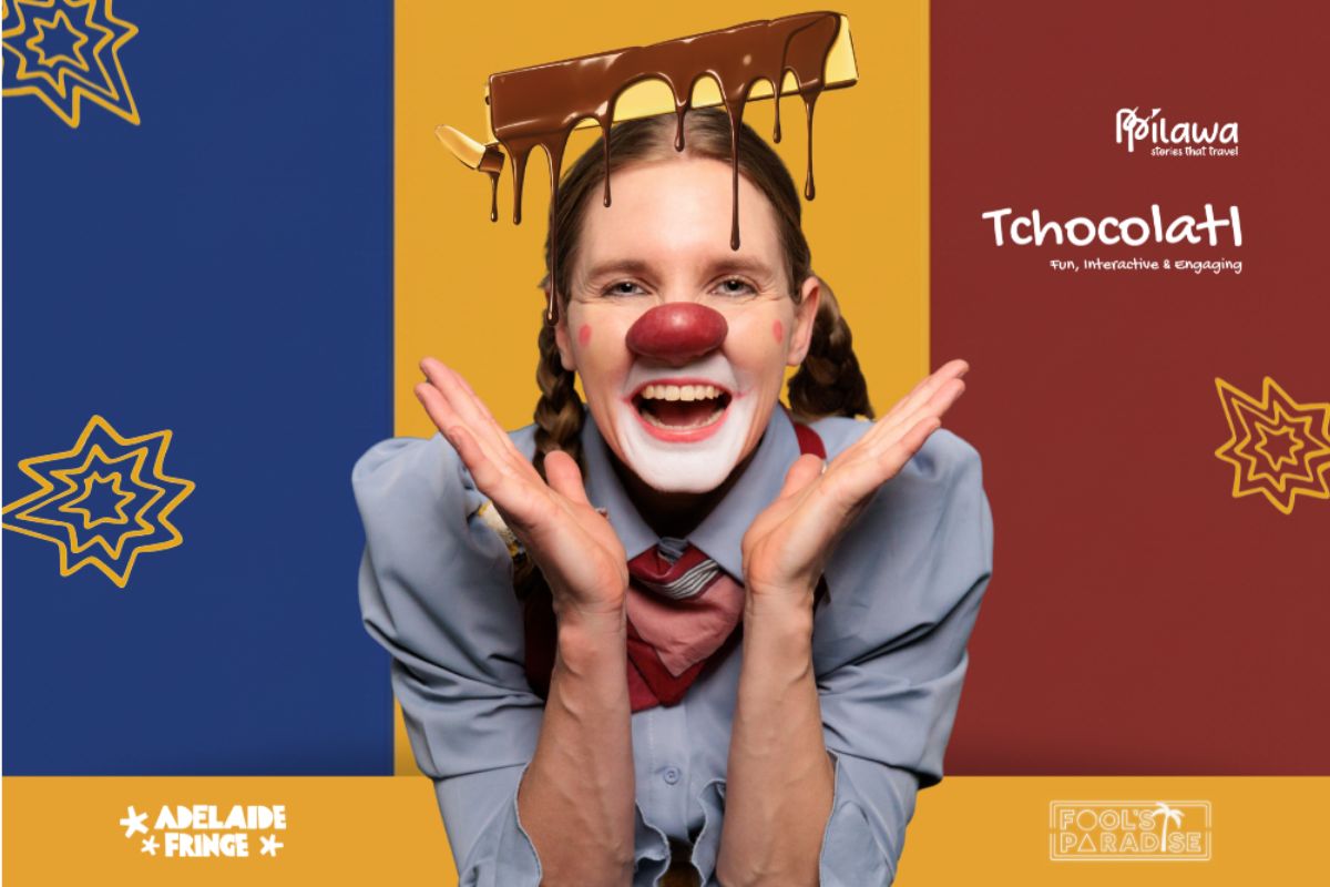 A woman dressed as clown with a red clown nose and chocolate poured on her head smiles in surprise