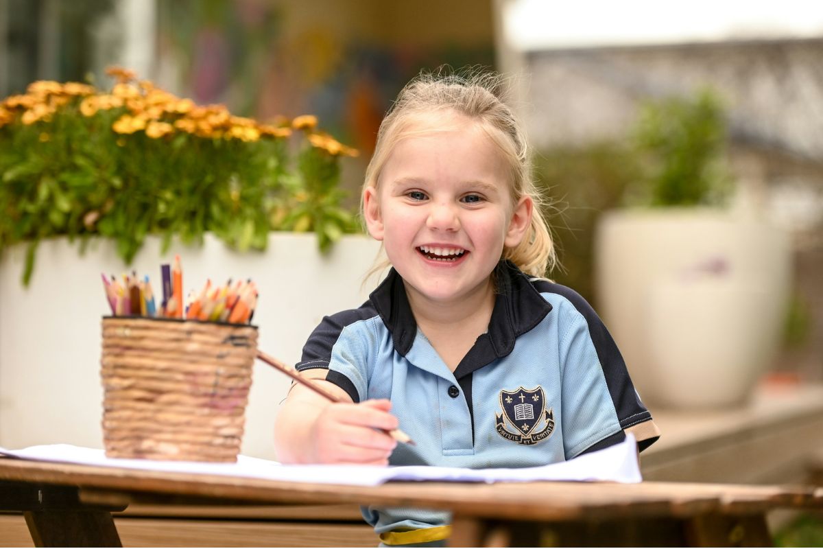 Walford School Adelaide student poses for a photo while drawing. 