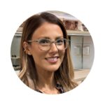 headshot of a woman wearing glasses and smiling warmly