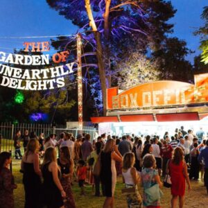 An extraordinary garden landscape showcasing vivid colours, plants, and a crowd of people, inviting exploration and curiosity.