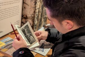 A student looks through some historical photographs for the History Trust of South Australia Ghosts activity.