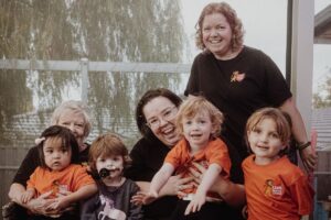 A group of adults pose for a group photo expressing happiness and joy.