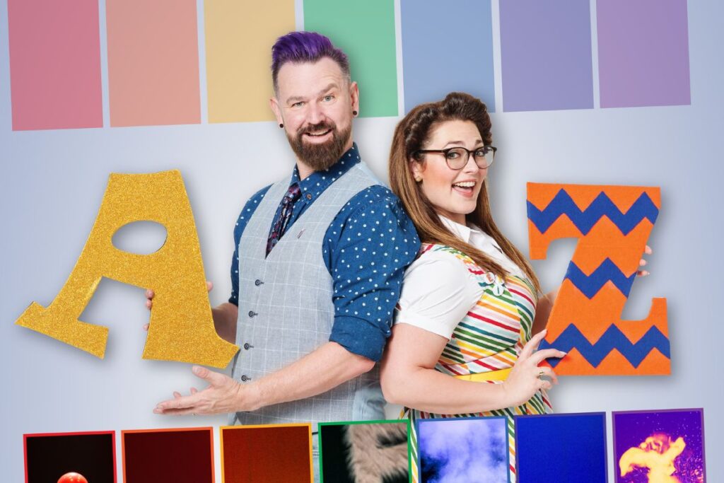 A man and women pose with letters of the alphabet in colourful clothing and surrounds