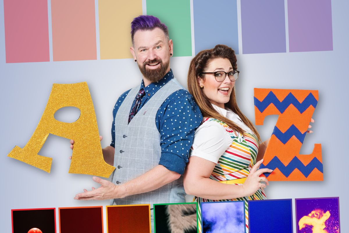 A man and women pose with letters of the alphabet in colourful clothing and surrounds