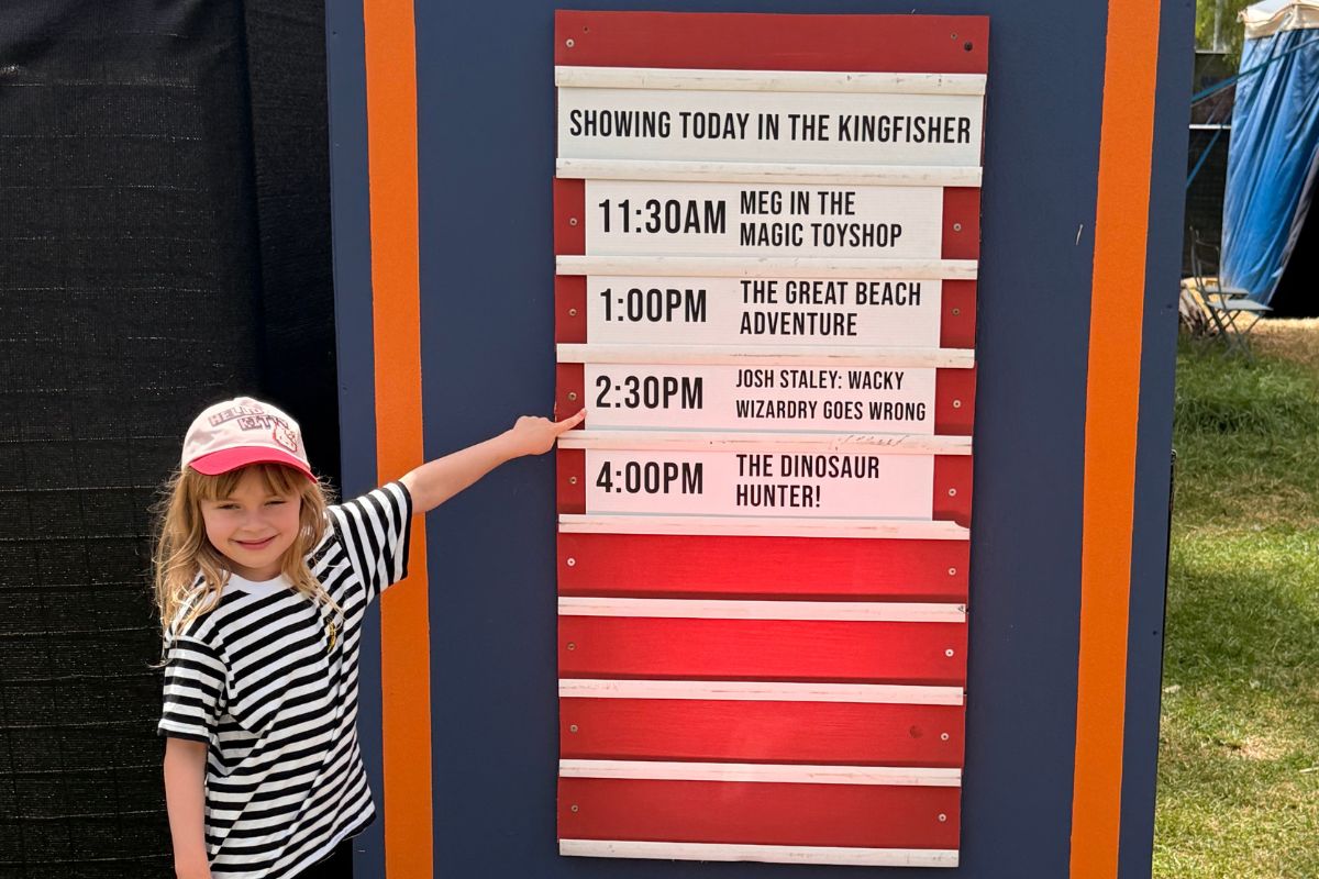 A girl points to the Adelaide Fringe show Josh Staley: Wacky Wizardry Goes Wrong, before the show starts.